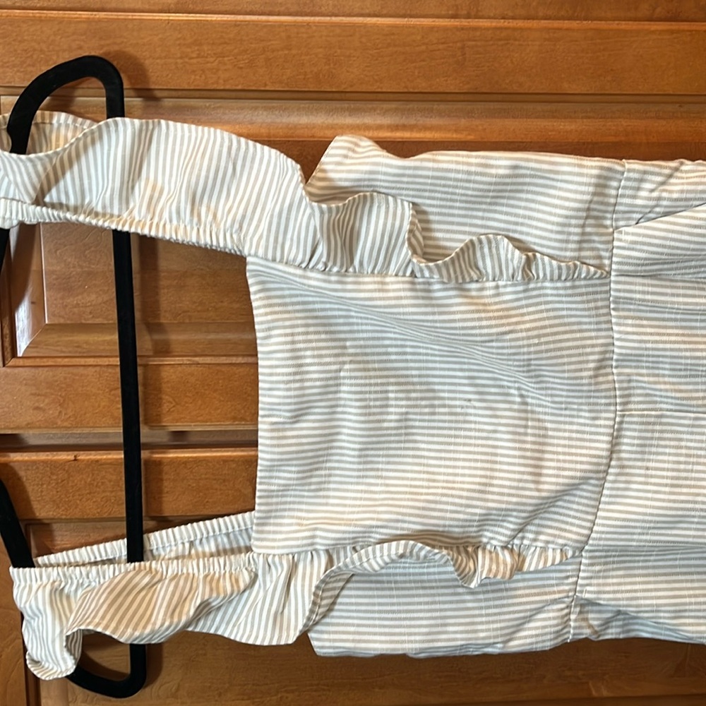 Ankle length tan and white striped jumpsuit with ruched back.